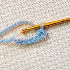 the crochet hook has been hooked up to an object that looks like it is knitting