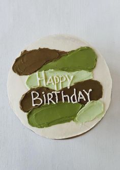 a birthday cake with the words happy birthday written on it in white frosting and green icing