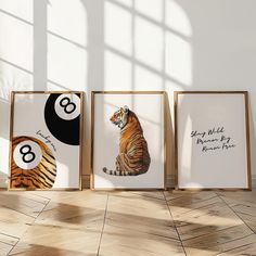 three framed photographs of tigers in front of a white wall with the number eight on it