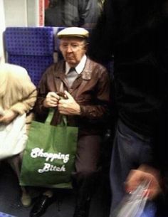 an older man sitting on a bus holding a shopping bag