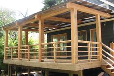 a small house with wooden decking and railings