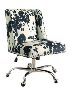 an office chair with black and white cow print upholstered on it's back