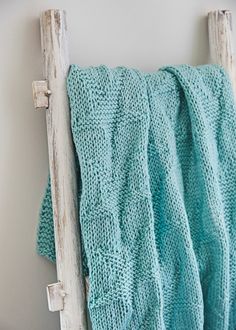 a blue blanket hanging on the side of a wall