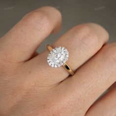 a woman's hand with a diamond ring on top of her finger and an engagement band