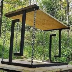 a wooden structure with chains hanging from it's sides