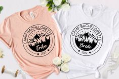 two t - shirts with mountains and the words backpackers are shown on them next to flowers