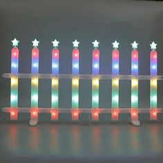 a row of lit up candles with stars on them