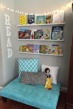 a room with bookshelves and a blue couch in front of the book shelf