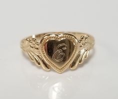 "Thanks for shopping our vintage estate store. We tend to sell well below wholesale and truly hope you enjoy all of our items. Many of the items are one of a kind, so please enjoy scrolling through the pictures and hopefully something will catch your eye. Brown spots are from camera or reflections. Estate 14k yellow gold monogram cursive capital E heart ring. Custom made ring for our shop. Ring size: 3 Setting: 7.5mm 1/4\" to 3/8\" Band width: 1.5mm Weight: .98 gram Marked 14k and it's sweet. On Mexican Gold Rings, Cursive E, Cursive B, Antique Style Rings, Jewelry Accessories Ideas, Dope Jewelry, Gold Monogram, Classy Jewelry, Jewelry Lookbook