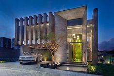 a car is parked in front of a modern house