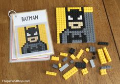 the lego batman book is next to it's contents on a wooden table,