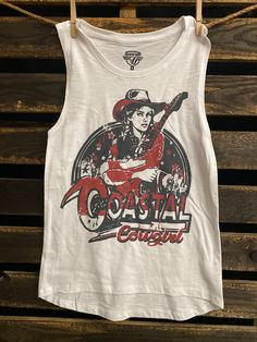 Country Deep Coastal Cowgirl Muscle tank top in Natural Color * Size S: Length measures 25" from shoulder to hem with a 14" bust * Size M: Length measures 26.5" from shoulder to hem with a 15" bust  * Size L: Length measures 27" from shoulder to hem with a 16" bust  * Size XL- Length measures 28" from should to hem with 17 inch bust * Runs true to size Fitted Sleeveless Cotton T-shirt, Stretch Sleeveless T-shirt With Graphic Print, Spring Cotton Racerback Muscle Tee, Cotton Racerback Muscle Tee For Summer, White Cotton Racerback Muscle Tee, Fitted Racerback T-shirt For Summer, Fitted Summer Muscle Tee Tank, Fitted Summer Tank Muscle Tee, Fitted Tank Muscle Tee For Summer