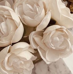 some white flowers sitting on top of a marble table