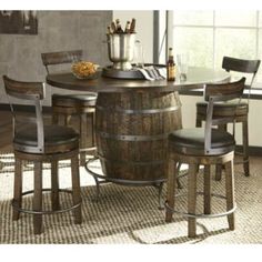 a kitchen table with stools and a wine barrel in the center, next to a window