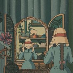 two children are looking at their reflection in the mirror while one girl is wearing a hat