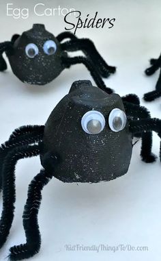 some black plastic balls with googly eyes on them and one has an egg carton spider