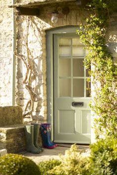 a pair of rain boots sitting in front of a door