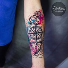 a person with a compass tattoo on their arm