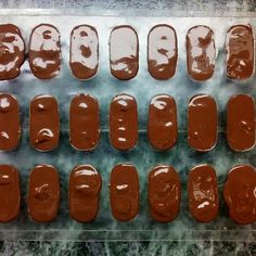 chocolate covered donuts are lined up on a baking sheet and ready to be baked