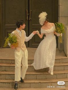 a young man and woman dressed in wedding attire walking down steps holding hands with each other