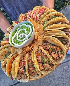 a platter filled with tacos and guacamole