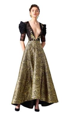 Get glam in this red carpet evening gown by Edward Arsouni Couture. The magnificent bodice has a dramatically plunging v-neckline and luscious lace elbow length sleeves with sophisticated pleated accents. This memorable ensemble sparkles with gilded adornments and shimmers to the long high-low silhouette hem in rich, paisley patterned waves.  #eveninggown #couture #fashion #womensfashion #blacktie V-neck Gown With Sheer Bodice For Party, Luxury Fitted V-neck Gown, Luxury V-neck Evening Gown, Glamorous V-neck Cocktail Gown, Elegant V-neck Evening Dress With Sheer Bodice, Fitted Bodice V-neck Evening Dress For Gala, Elegant Evening Ball Gown With Sheer Bodice, Elegant V-neck Ball Gown For Gala, Couture Floor-length Ball Gown For Party