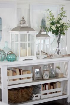 an image of a white shelf with books and vases on it's shelves