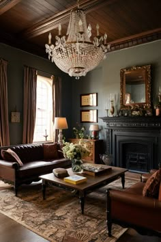 a living room filled with furniture and a chandelier hanging from the ceiling in front of a fire place