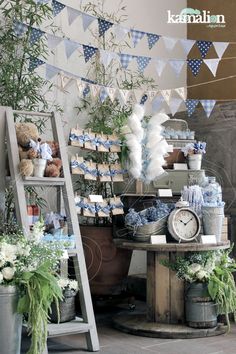 there is a table with blue and white decorations in the corner, along with two ladders