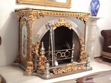 an ornate fireplace with gold and silver decorations