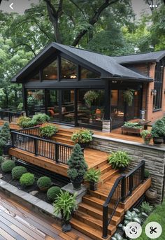 a house that has some plants on the front porch and stairs to the second floor