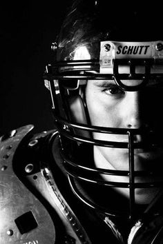 a black and white photo of a football player wearing a helmet with the word schutt on it