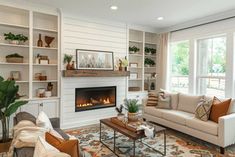 a living room filled with furniture and a fire place in the middle of a room