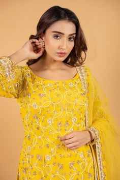 Yellow hand embroidered kurta with floral motifs. Paired with gharara and dupatta.
Component: 3
Pattern: Embroidered
Type Of Work: Floral motifs
Neckline: Round
Sleeve Type: Three quarter
Fabric: Georgette,net
Color: Yellow
Other Details: 
Floral embroidered
Pleated gharara
Sheer dupatta
Embroidered border
Occasion: Mehendi and Haldi - Aza Fashions Designer Sharara With Intricate Embroidery And Straight Kurta, Designer Bollywood Sharara With Resham Embroidery, Festive Unstitched Sharara With Intricate Embroidery, Festive Chinon Sharara With Intricate Embroidery, Chanderi Sharara With Intricate Embroidery And Straight Kurta, Semi-stitched Sharara With Intricate Embroidery And Straight Kurta, Intricate Embroidered Semi-stitched Sharara With Straight Kurta, Anarkali Designer Sharara With Intricate Embroidery, Eid Sharara With Intricate Embroidery And Straight Kurta