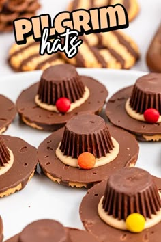 there are many desserts with hats on the top one is chocolate and has candy candies around it