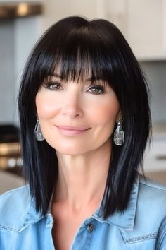 Save this pin for the best medium-length hairstyles for women over 50 with bangs. Sleek and polished, this mid-length hairstyle uses long layers to add subtle movement while maintaining a smooth, straight shape. Full, piecey bangs soften the forehead. Piecey Bangs, Medium Length Hair With Bangs, Long Bob With Bangs