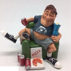 a figurine of a man sitting on a chair with pizza and sodas