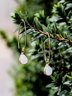 These streamlined earrings feature Druzy Teardrops in a gorgeous shade of white, secured in my original bezel wrapped style in your choice of metal, suspended from handmade ear wires hammered and formed into a modern almond shape. The finished product is a long linear earring that is super unique also light weight and comfy enough that you could forget you're wearing them. The shape of these ear wires is an intentional design meant to keep these earrings in place, and it works beautifully. This White Teardrop Wire Wrapped Earrings, Adjustable Teardrop Pendant Earrings As Gift, White Long Drop Threader Earrings As Gift, Adjustable Nickel-free White Teardrop Earrings, White Wire Wrapped Drop Earrings, White Wire Wrapped Drop Crystal Earrings, White Teardrop Linear Earrings Dainty Style, White Wire-wrapped Drop Crystal Earrings, White Wire Wrapped Drop Jewelry