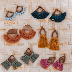 six pairs of tasseled earrings on a woven surface