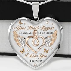 a heart shaped necklace with two wings and the words, your heart stopped but my love for you not i love you forever