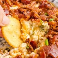 a close up of food on a plate with a person touching the top of it