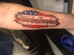 a man's arm with an american flag and the words we are home on it