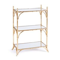 a gold bamboo shelf with three glass shelves on each side and one shelf below it