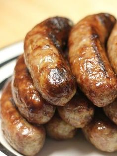 several sausages are stacked on a white and black plate