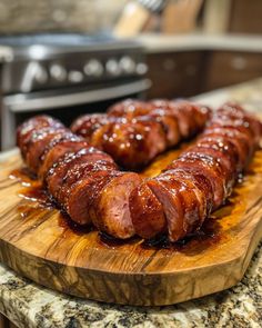 some sausages on a wooden cutting board in the middle of a kitchen counter top