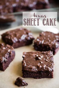 brownies with chocolate frosting sitting on top of a cutting board