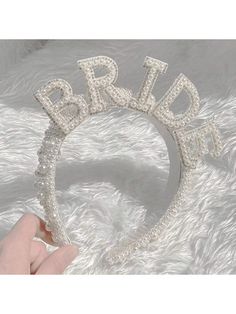 a bridal tiara with the word bride written in crystal beads on it's side