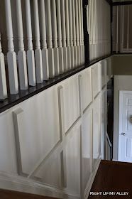 an empty hallway with white doors and black trim on the wall next to a door