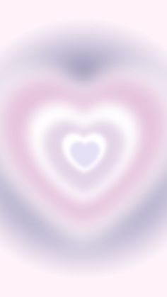 a blurry image of a heart shaped object in pink and blue colors with white center