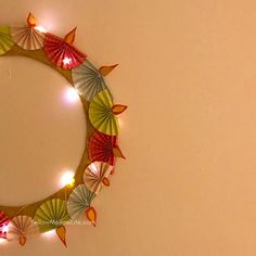 a wreath made out of paper with lights around it